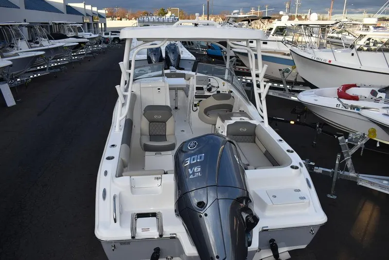 Slide: The Image of 2025 Key West 239 DFS boat with powerful 300 V6 engine, docked among other boats. - 8