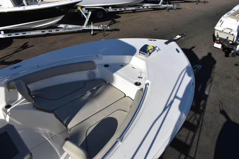 Slide: The Image of 2025 Key West 244 CC boat interior with seating and storage, parked on a trailer. - 13