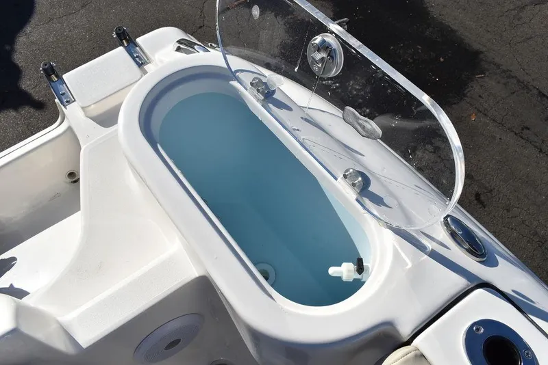 Slide: The Image of 2025 Key West 244 CC boat livewell with open lid, showcasing interior design. - 23