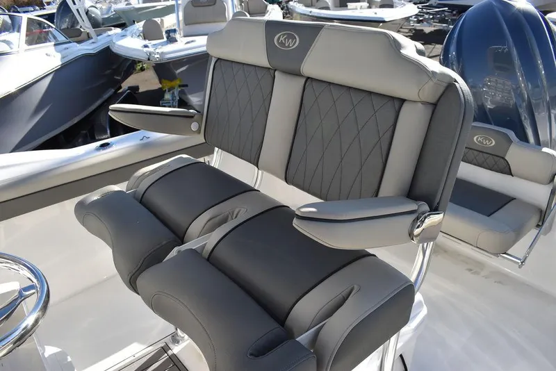 Slide: The Image of 2025 Key West 244 CC boat seating with gray cushioned design and armrests. - 29