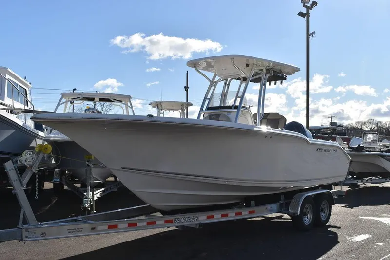 Slide: The Image of 2025 Key West 244 CC boat on trailer under clear sky. - 3