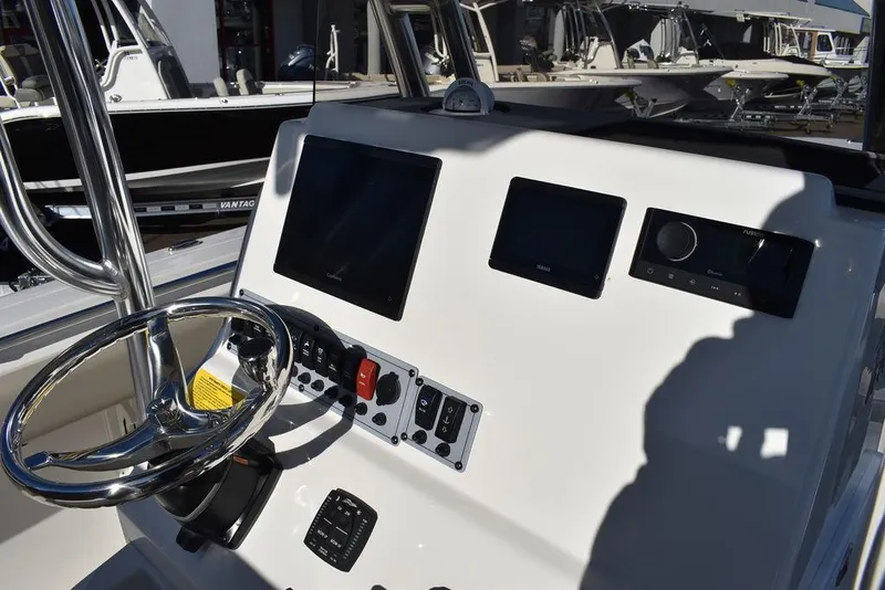 Slide: The Image of 2025 Key West 244 CC boat dashboard with steering wheel and electronic displays. - 32