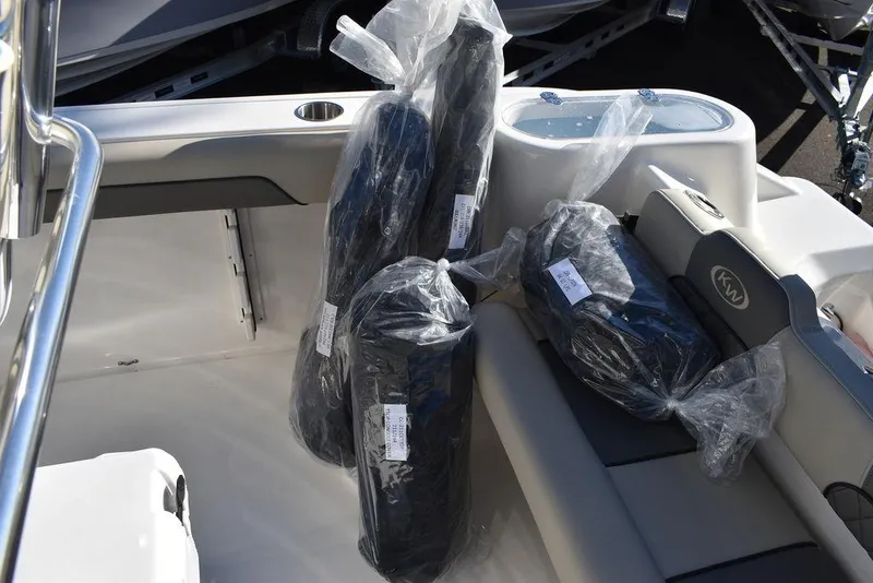Slide: The Image of 2025 Key West 244 CC boat interior with packaged accessories on seats. - 41