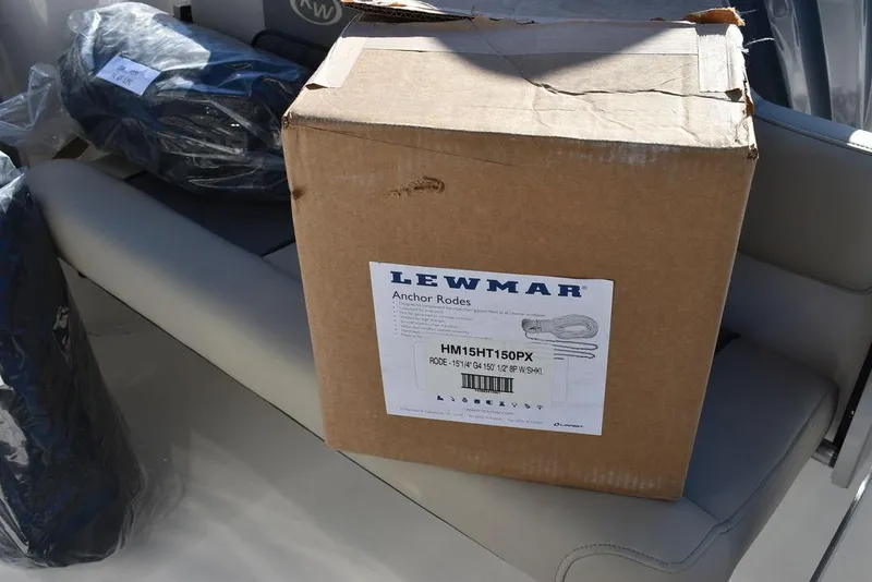 Slide: The Image of Cardboard box labeled "Lewmar Anchor Rode" on Key West 244 CC boat seat, 2025 model. - 42