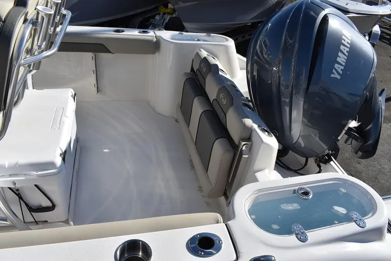 Slide: The Image of 2025 Key West 244 CC boat interior with Yamaha engine, featuring seating and storage. - 15