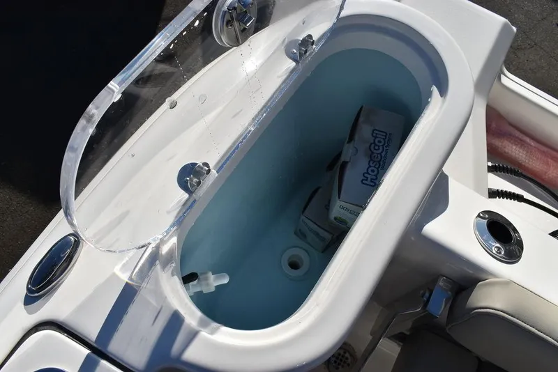 Slide: The Image of Livewell compartment on 2025 Key West 244 CC boat, featuring clear lid and storage space. - 22