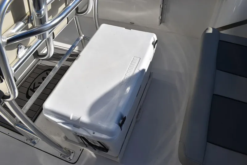 Slide: The Image of Key West 244 CC 2025 boat interior with cooler and seating area. - 25
