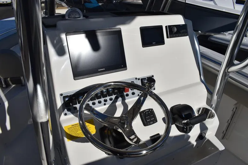 Slide: The Image of 2025 Key West 244 CC boat dashboard with steering wheel and electronic displays. - 31