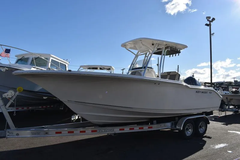 Slide: The Image of 2025 Key West 244 CC boat on trailer under clear blue sky. - 4