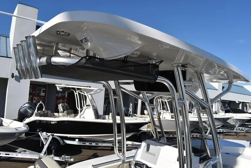 Slide: The Image of 2025 Key West 244 CC boat with T-top and rod holders, displayed at a marina. - 9