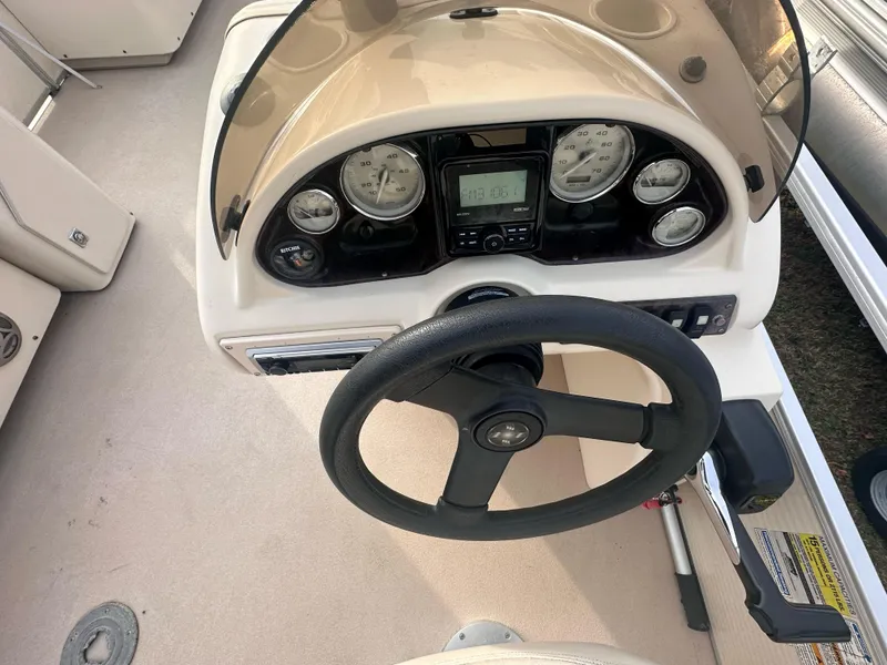Slide: The Image of Steering console of 2010 Sweetwater 2586RE Sport 4gate boat with gauges and controls. - 3