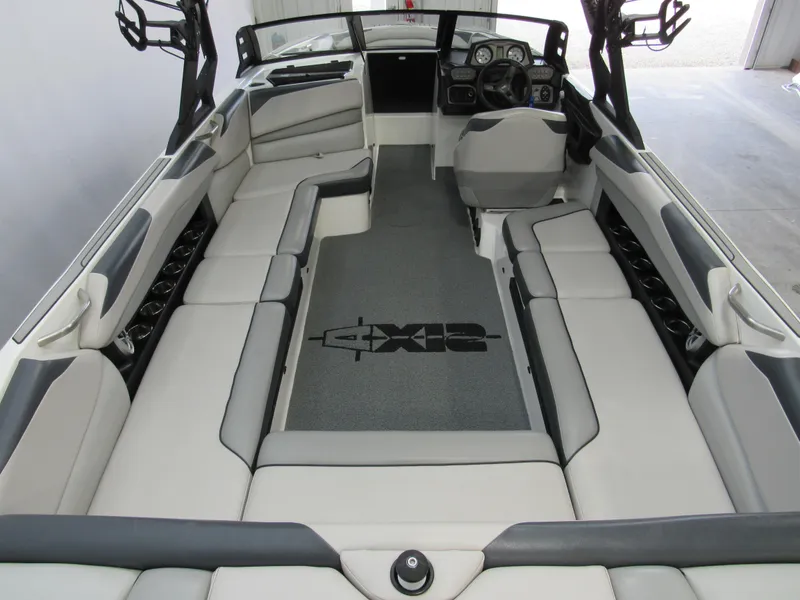 Slide: The Image of 2018 Axis A24 boat interior with spacious seating and modern dashboard. - 4