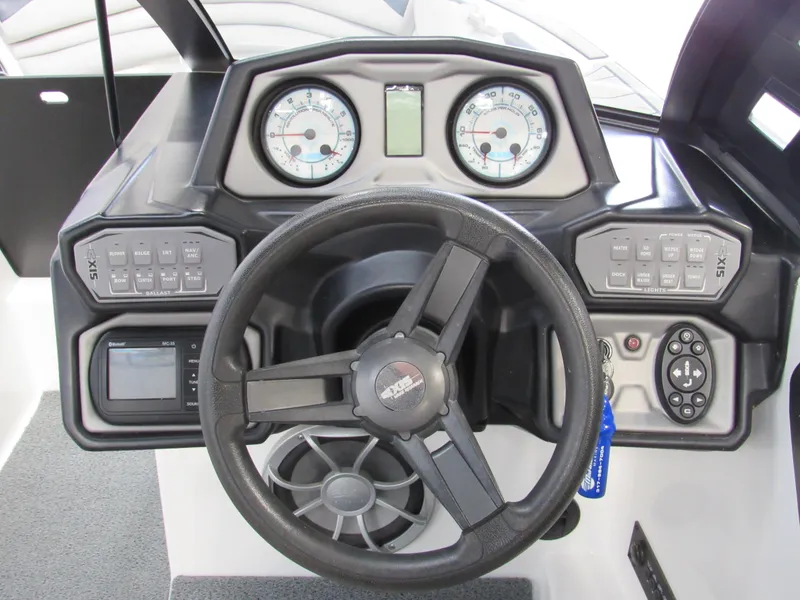 Slide: The Image of 2018 Axis A24 boat dashboard with steering wheel and control panel. - 7