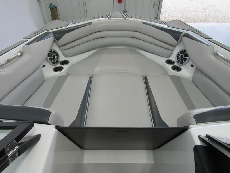 Slide: The Image of 2018 Axis A24 boat interior with gray seating and built-in speakers. - 8