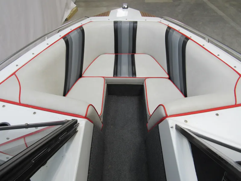 Slide: The Image of 1990 Centurion Falcon BR boat interior with white and black seating, red trim accents. - 11