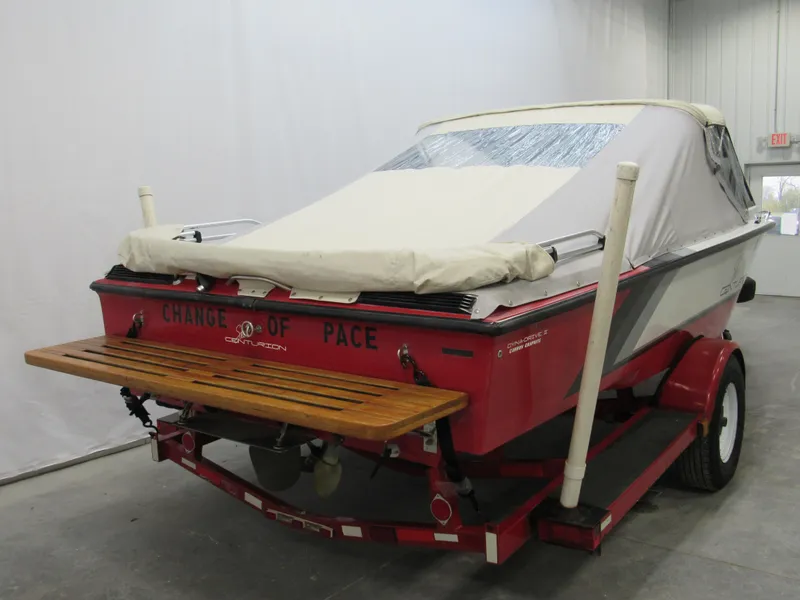 Slide: The Image of 1990 Centurion Falcon BR boat with cover on trailer in garage. - 3