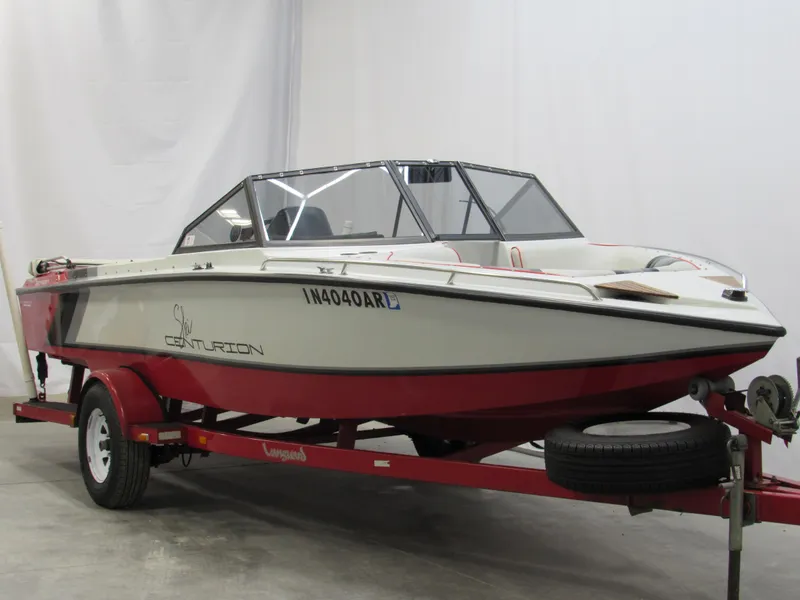 Slide: The Image of 1990 Centurion Falcon BR boat on red trailer in indoor setting. - 5