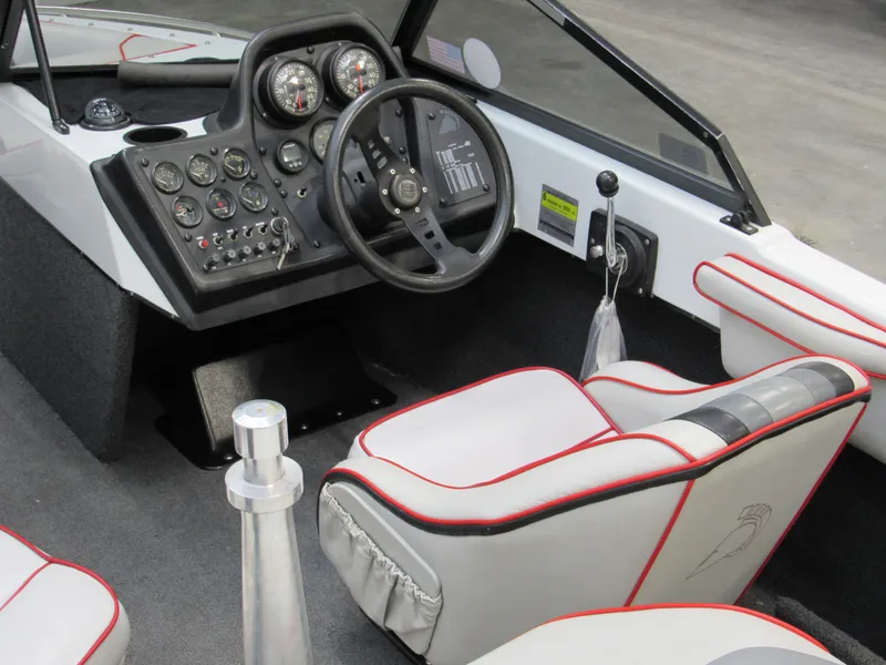 Slide: The Image of 1990 Centurion Falcon BR boat interior with steering wheel and control panel. - 9