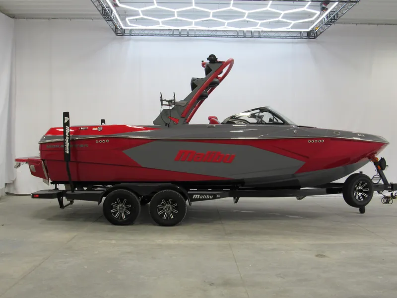 The Image of 2025 Malibu Wakesetter 23 LSV boat in red and gray on trailer. - 0