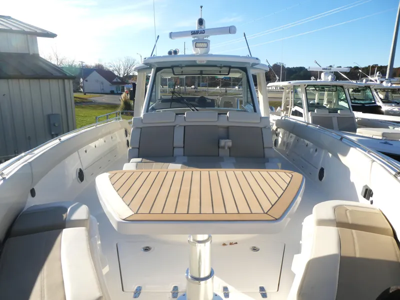 Slide: The Image of 2025 Boston Whaler 420 Outrage boat with spacious deck and seating area. - 11