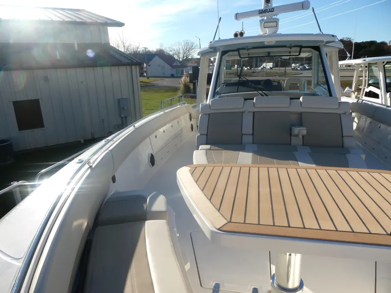 Slide: The Image of 2025 Boston Whaler 420 Outrage boat with spacious deck and modern design. - 13