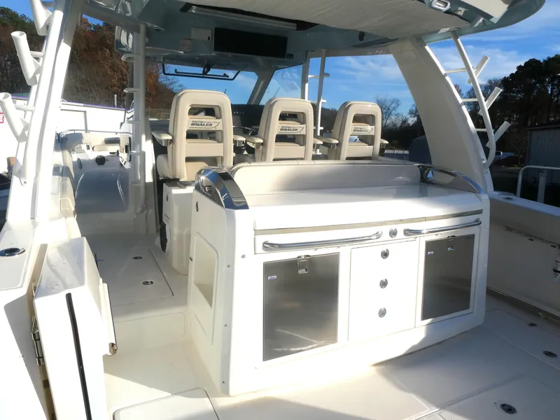 Slide: The Image of 2025 Boston Whaler 420 Outrage interior with seating and storage. - 16