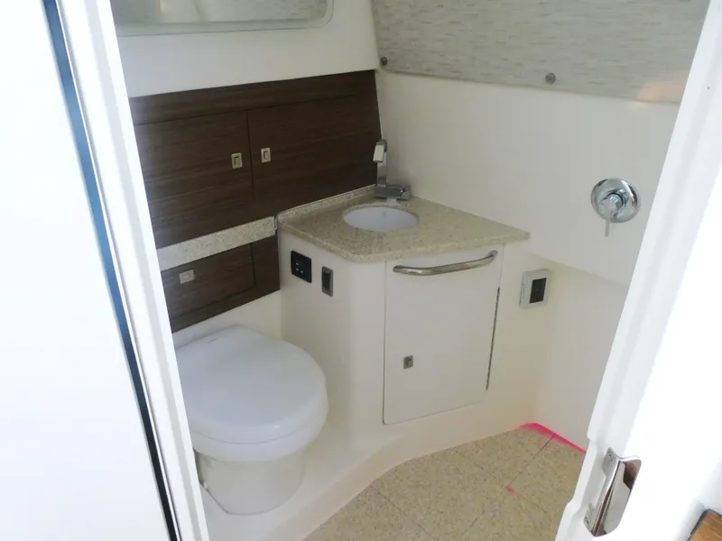Slide: The Image of 2025 Boston Whaler 420 Outrage bathroom with modern fixtures and wood accents. - 21