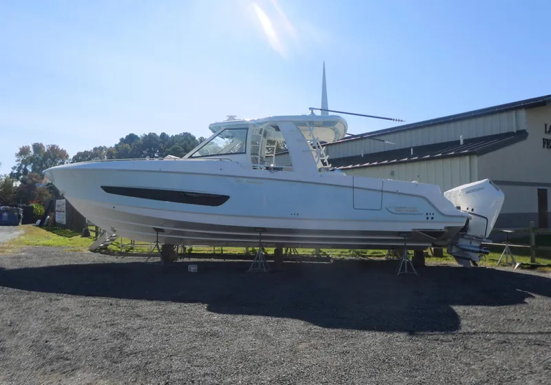 Slide: The Image of 2025 Boston Whaler 420 Outrage boat on display outdoors. - 3