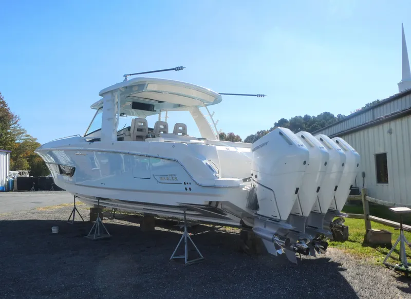 Slide: The Image of 2025 Boston Whaler 420 Outrage boat with four engines on display outdoors. - 4