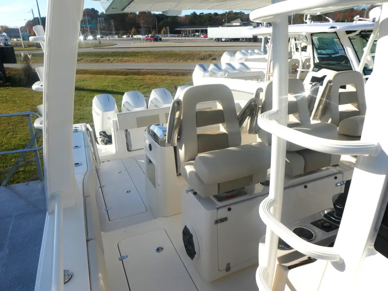 Slide: The Image of 2025 Boston Whaler 420 Outrage boat interior with seating and multiple engines. - 9