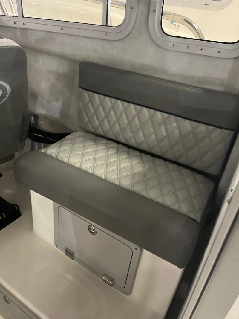 Slide: The Image of Interior seating of 2025 Defiance Admiral 260 EX boat, featuring quilted upholstery. - 10