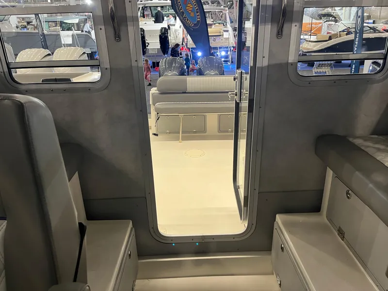 Slide: The Image of Interior view of 2025 Defiance Admiral 260 EX boat at a showroom. - 12