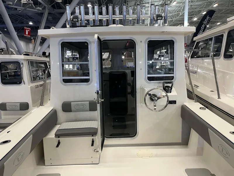 Slide: The Image of 2025 Defiance Admiral 260 EX boat interior with helm and seating. - 4