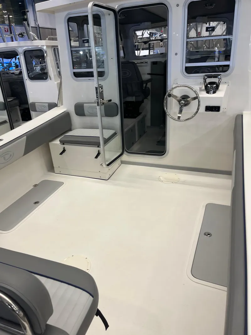 Slide: The Image of 2025 Defiance Admiral 260 EX boat interior with seating and steering wheel. - 5