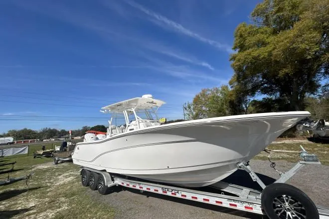 Slide: The Image of 2020 Sea Fox Commander 328 boat on trailer under clear blue sky. - 0