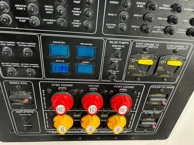Slide: The Image of Control panel of a 2020 Sea Fox Commander 328 boat with various switches and gauges. - 15