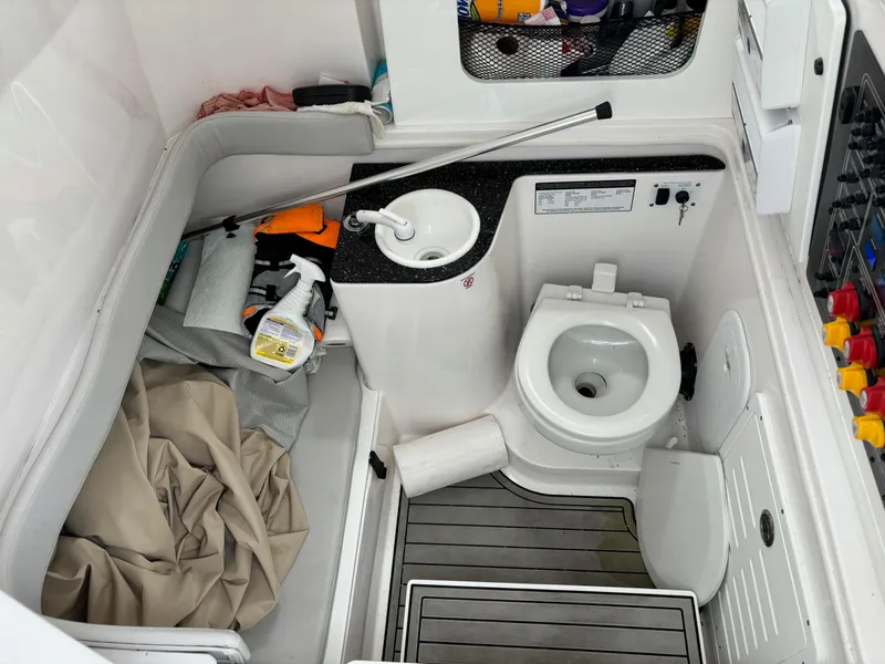Slide: The Image of 2020 Sea Fox Commander 328 boat bathroom with toilet, sink, and storage area. - 16