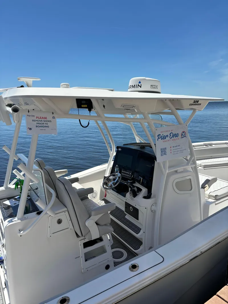 Slide: The Image of 2020 Sea Fox Commander 328 boat docked on calm water under clear blue sky. - 6