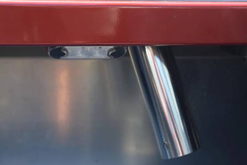 Slide: The Image of Stabicraft 1550 Fisher Profish 2025, close-up of metal rod holder on red and silver surface. - 12