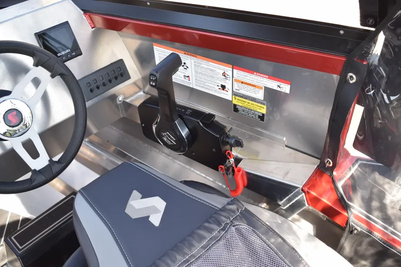 Slide: The Image of Interior of 2025 Stabicraft 1550 Fisher Profish boat, featuring steering wheel and control panel. - 16