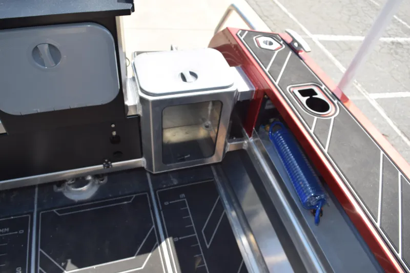 Slide: The Image of 2025 Stabicraft 1550 Fisher Profish boat interior with storage compartments and fishing rod holder. - 23