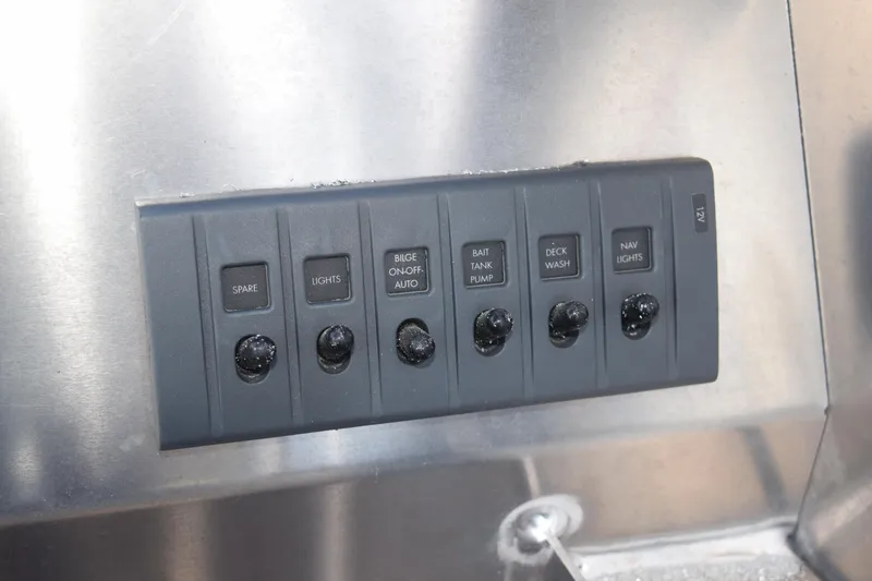 Slide: The Image of Control panel of 2025 Stabicraft 1550 Fisher Profish boat with labeled switches. - 25