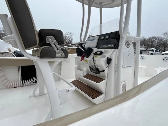 Slide: The Image of 2021 Tidewater 220 CC Adventure boat interior with helm and seating. - 16