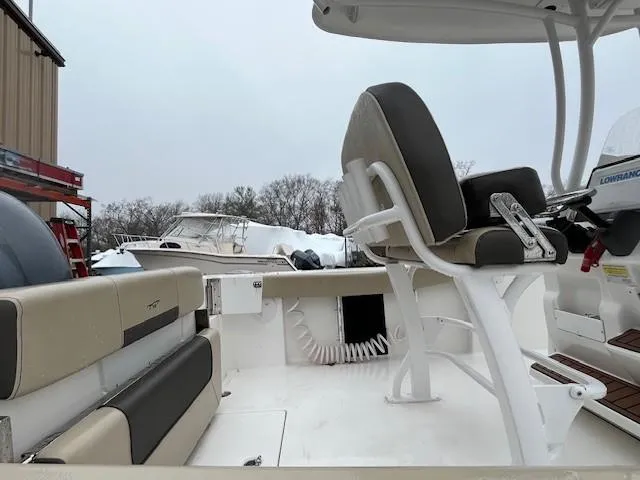 Slide: The Image of 2021 Tidewater 220 CC Adventure boat interior with seating and helm. - 17