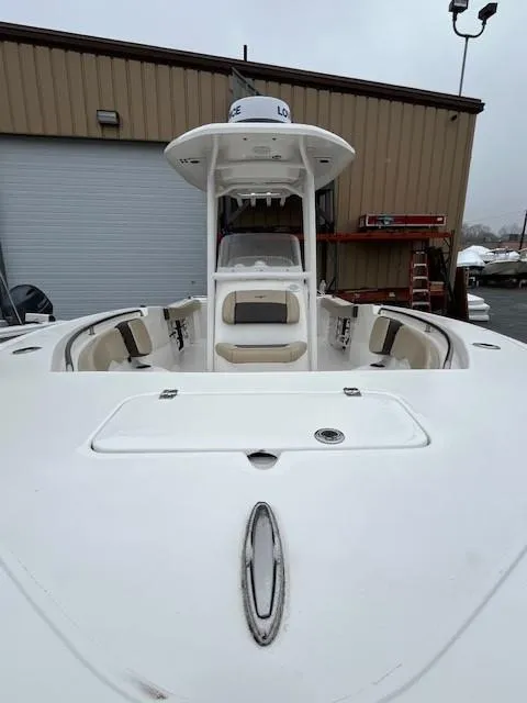Slide: The Image of 2021 Tidewater 220 CC Adventure boat, white exterior, docked near a warehouse. - 18