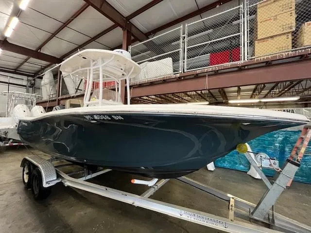 Slide: The Image of 2021 Tidewater 220 CC Adventure boat on trailer in warehouse. - 2
