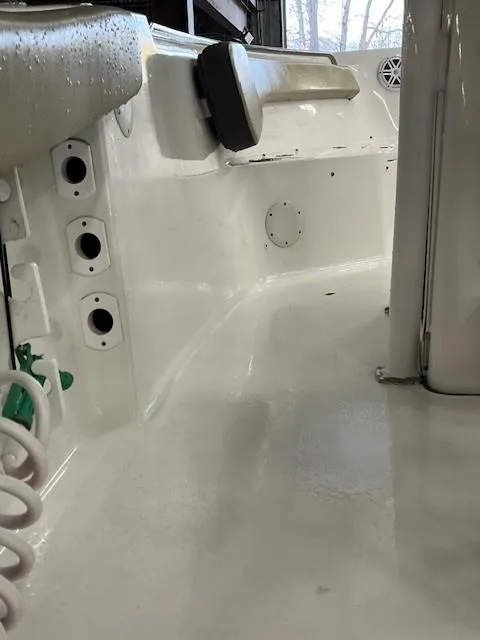 Slide: The Image of 2021 Tidewater 220 CC Adventure boat interior, showcasing clean white deck and seating area. - 20