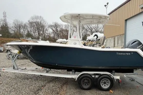 Slide: The Image of 2021 Tidewater 220 CC Adventure boat on trailer, parked outdoors. - 5