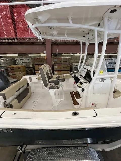 Slide: The Image of 2021 Tidewater 220 CC Adventure boat interior with seating and console. - 6