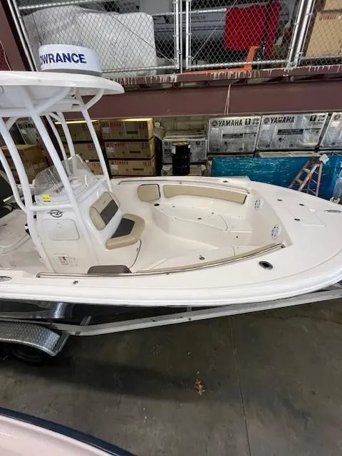 Slide: The Image of 2021 Tidewater 220 CC Adventure boat in storage, featuring spacious deck and modern design. - 7